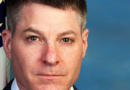 Bryan Vorndran, assistant director of the FBI’s Cyber Division, standing in front of a U.S. flag, looking stern